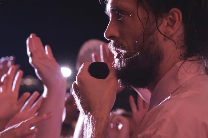 After allowing a fan to sing one verse of a song, vocalist Alex Ebert stands just outside the barricade to sing near the crowd. Edward Sharpe and the Magnetic Zeros performed Friday, July 31 at 9:30 pm.