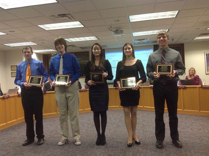 National Merit scholars (from left to right) seniors Josh Boeschen, Austin Busch, Vivian Wu, Katie Giles, and Jeff Carley pose with their plaques of recognition. The scholars received these plaques at the Feb. 5 board meeting. Not pictured: senior Mark Gee.