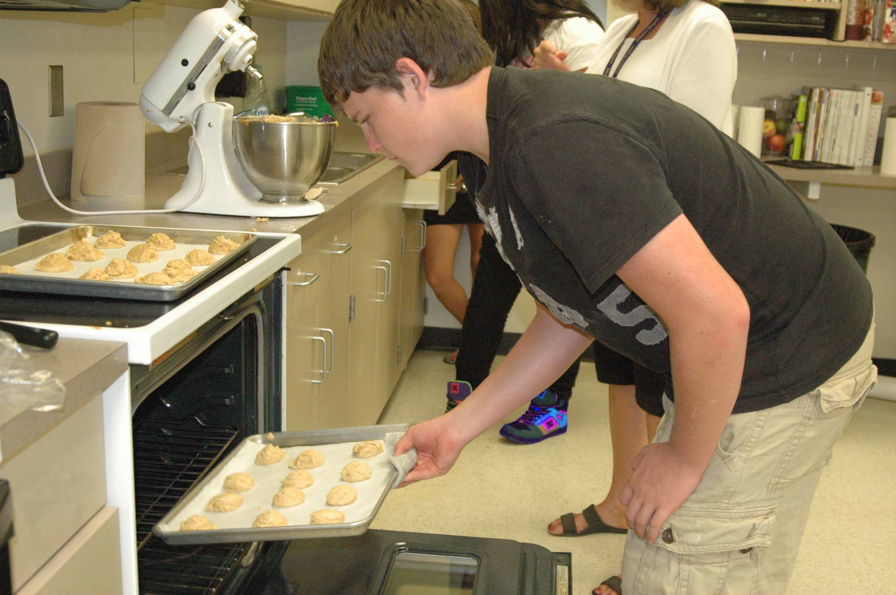 Junior Mitch Jaworski puts in a batch of FCS cookies in class.
