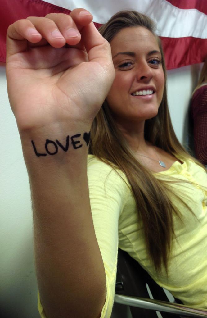 Senior Taylor Kilstrom writes Love on her wrist as a way to participate in Suicide Prevention Day, Sept. 10th, 2013. Kilstrom is participating to honor of a family member who passed away because of suicide. 
