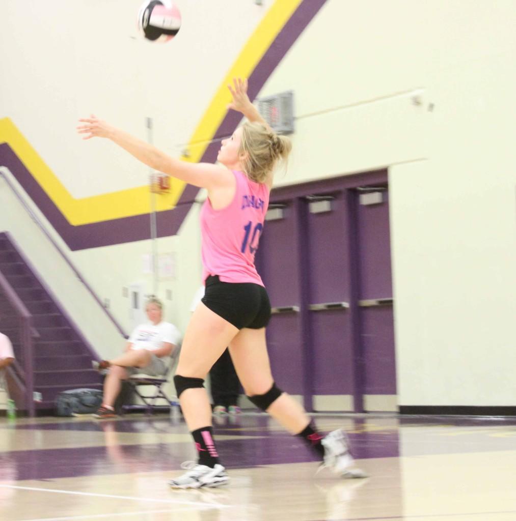 Senior Emily Hanson serves the ball during Dig Pink Spike Blue. Dig Pink Spike Blue is a match held annually by the Johnston volleyball team. 