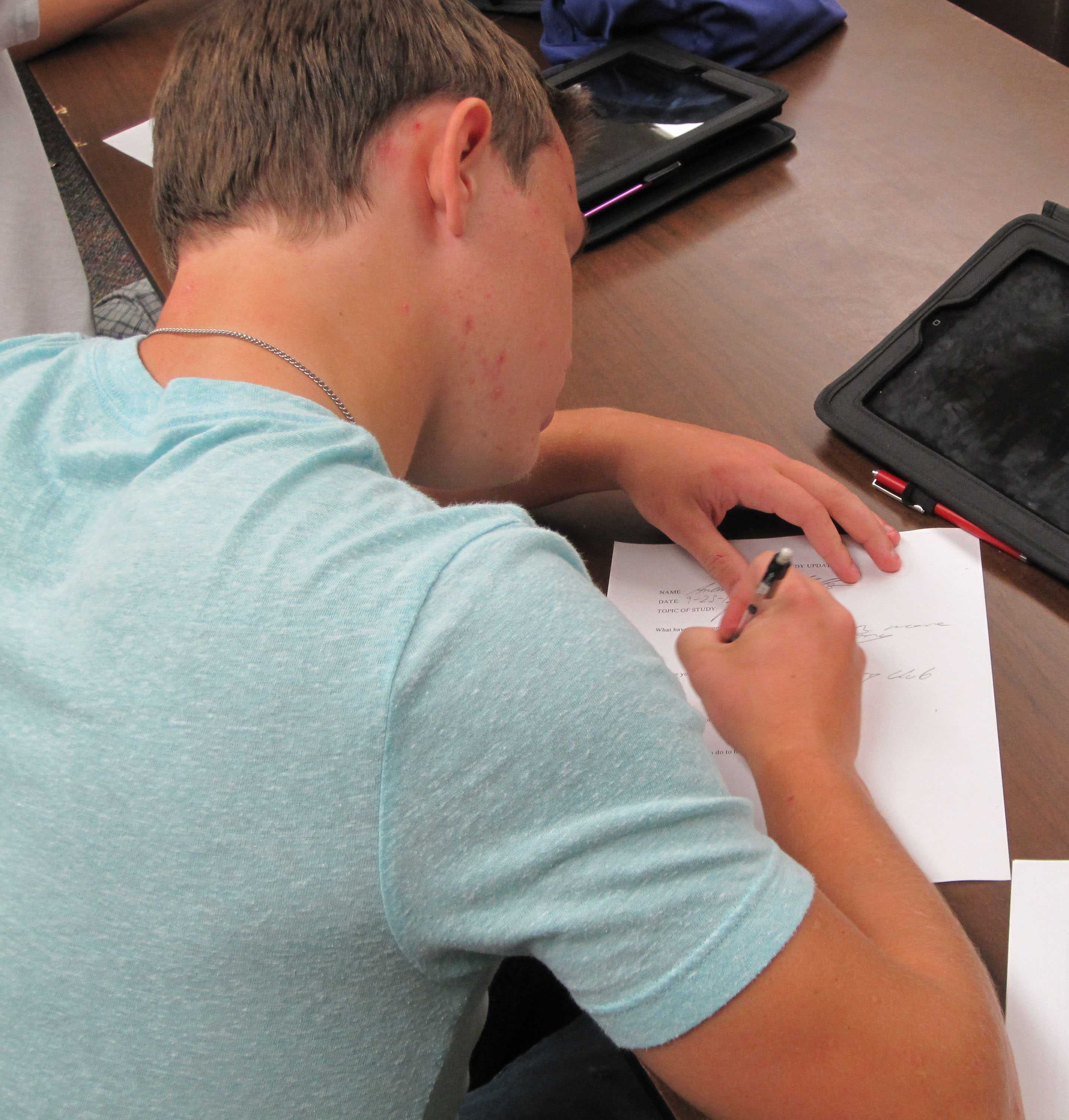 Senior Andrew Mills fills out paperwork needed for poetry club to be approved. He has been working hard to get poetry club to be approved, and hopes to have the first meeting in October. 