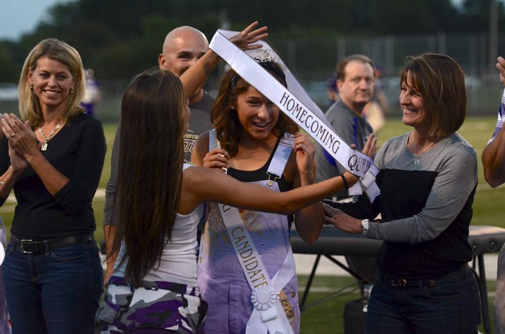 Senior Mackenzie Foldes receives her Homecoming Queen sash from Junior Abby Gorsche at the football game friday night. I was shocked to say the least, Foldes said.  I was just surprised I got it. All I heard was my dad saying, You actually won, which was really funny because I was thinking the same thing. Senior Pete Lashier was crowned as the Homecoming King. Lashier and Foldes were elected by 430 voting students.
