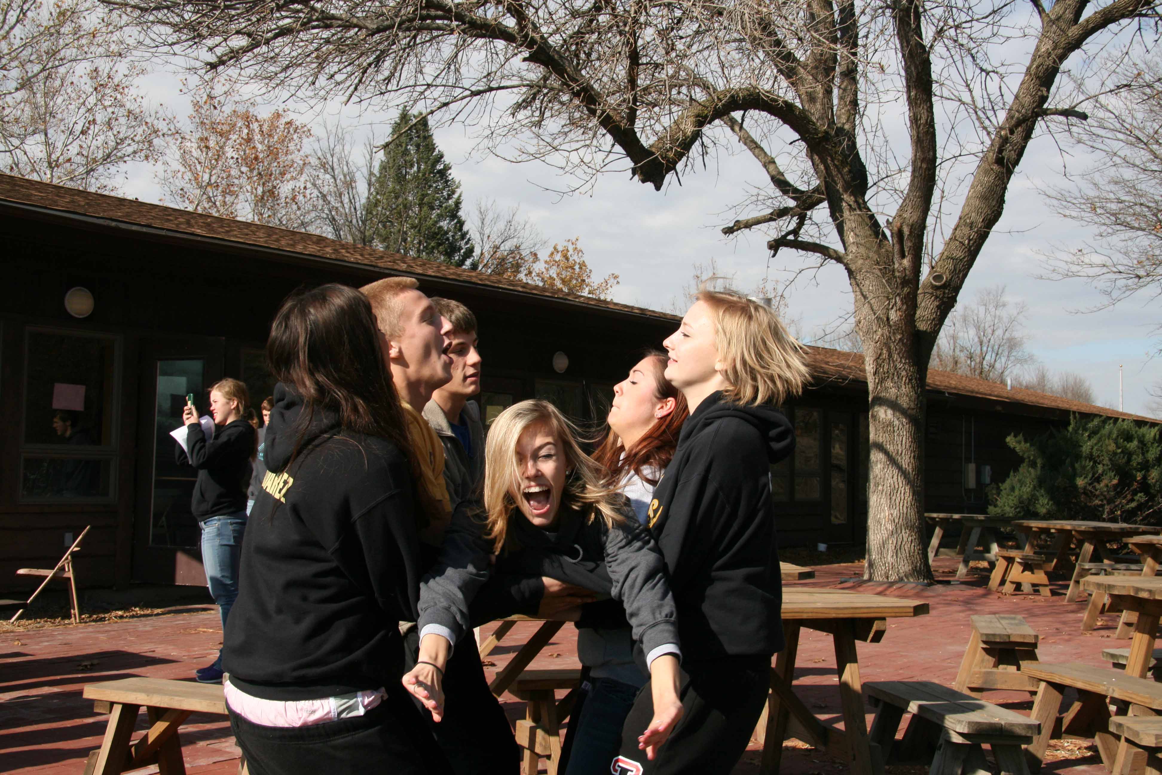Giving up her security, junior Abby Stevens is caught in her groups arms. On Nov. 2-3 there is an annual leadership weekend where students learn what it takes to be a good leader and build new friendships.