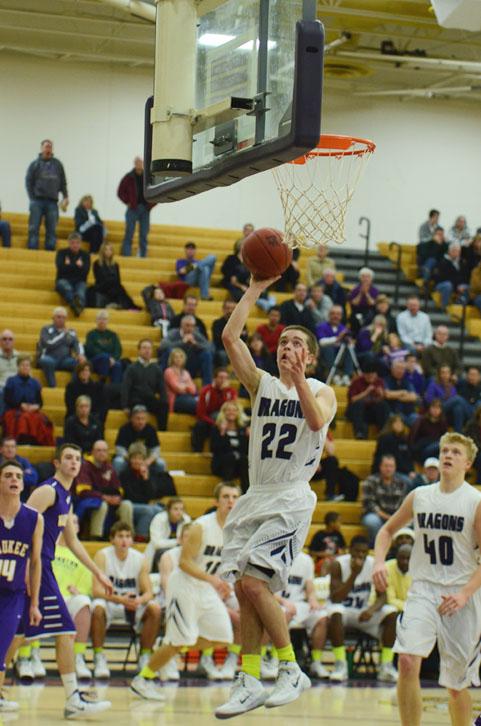 Number 22, junior Nick Neumann goes for a lay-up while number 40, junior Regen Siems waits to rebound the shot. 
