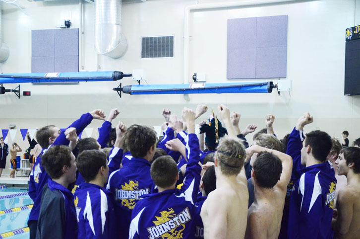 The boys swim team pumps up before the start of their meet. Johnston defeated Ames 103-67.