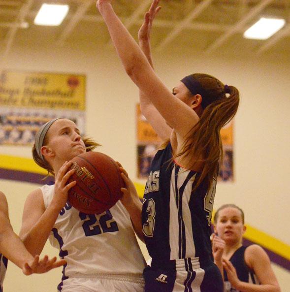 Sophomore Shayna Stubbs pushes past an offender to make a shot. The dragons won 74-34.
