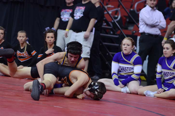 Sophomore Alec Ksiazek wrestles his opponent in the state tournament at Wells Fargo Arena.
