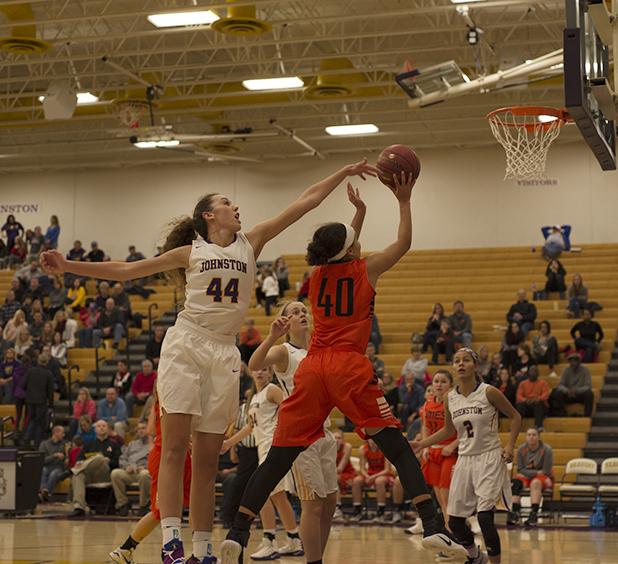 Taryn Knuth' 19 attempts to block an Ames player. The girls won against the Little Cyclones Friday, Dec 2.