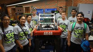 Left to right: Team ASAP members Sanjana Amatya '19, Shreya Shrestha '20, Prithvi Jamadagni '20, Bobby Bailey '17, Triston Walsh '17, Kyle Goben '20, Dheepak Naluri '17, Afshan Chandani '17 pose for a photo with the robot the team worked on. The team worked on the robot for six weeks prior to the competition. Not pictured: Tess Kern '19