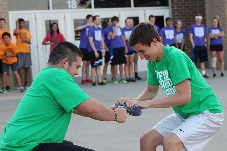 Seniors Tom Dusen and Nicholas Hanstad attempt to unroll a frozen T-shirt. The top three teams competed in the frozen T-shirt challenge.