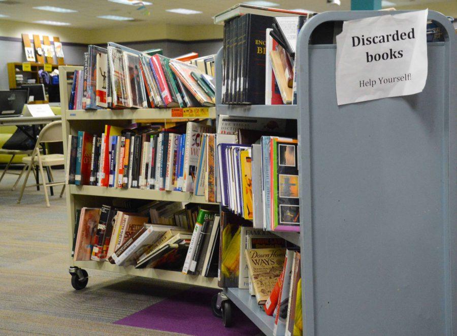 The cart of books has been placed out by Ruth Thoreson for students or teachers to take from. The books are some of the ones being removed from the library shelves, and Thoreson hopes people take them and enjoy their stories.