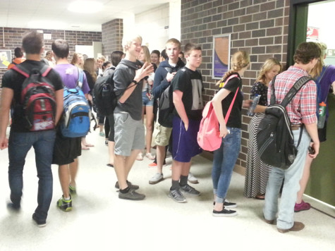 Students stand in line at the accounting office after school to purchase prom tickets.