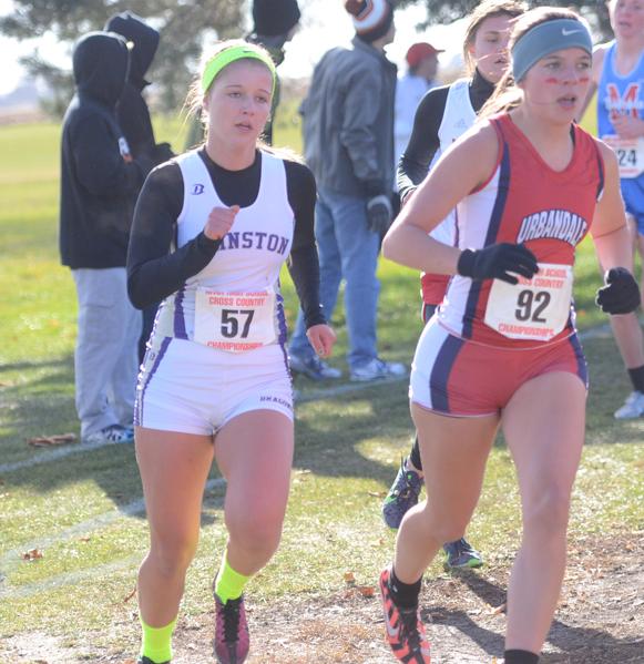 Junior Maddy Bradley begins to pass an Urbandale runner during the state meet. Urbandale finished second behind Johnston by 18 points. 