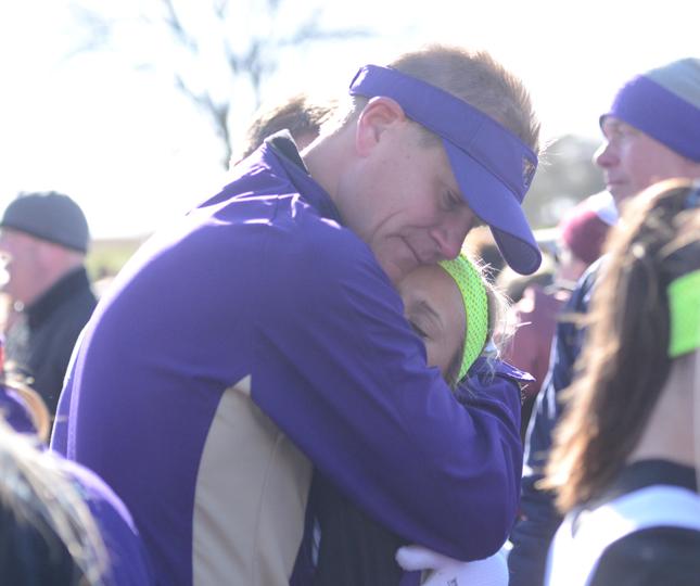 Head girls cross country coach Patrick Hennes hugs and consoles senior Jordyn Kleve after her second place finish at the cross country meet. 