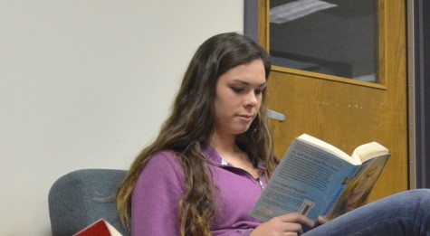 Junior Megan Kimrey was captured reading her book in the library.
