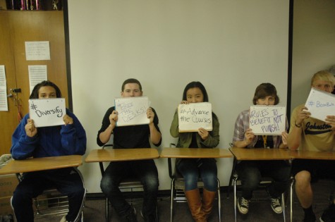 The design team holds up signs stating what they want to talk about during in-service days.