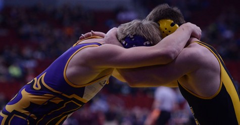 Junior Ben Wilson (182) wrestles with Southeast Polk's Kameron Padavich during the first round consolation match. Wilson lost 4-2, eliminating him from the tournament.