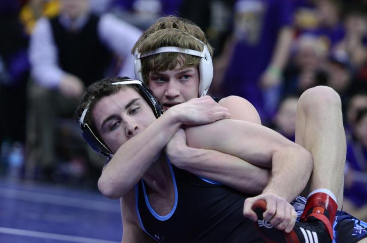 Freshman Sam Nielson (132) wrestles his opponent during the team duels at the state tournament Wednesday at Wells Fargo Arena.