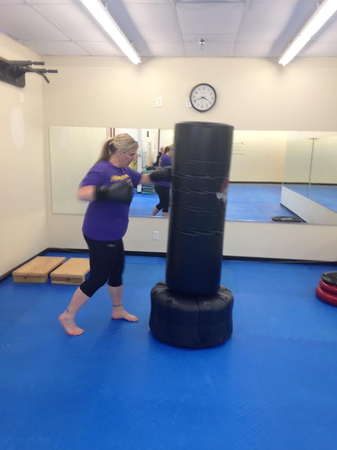 Teacher Jennifer Palmer works out at a Farrells Extreme Bodyshaping kickboxing class. Palmer, along with other teachers, are in the middle of their third week of the fitness challenge. 