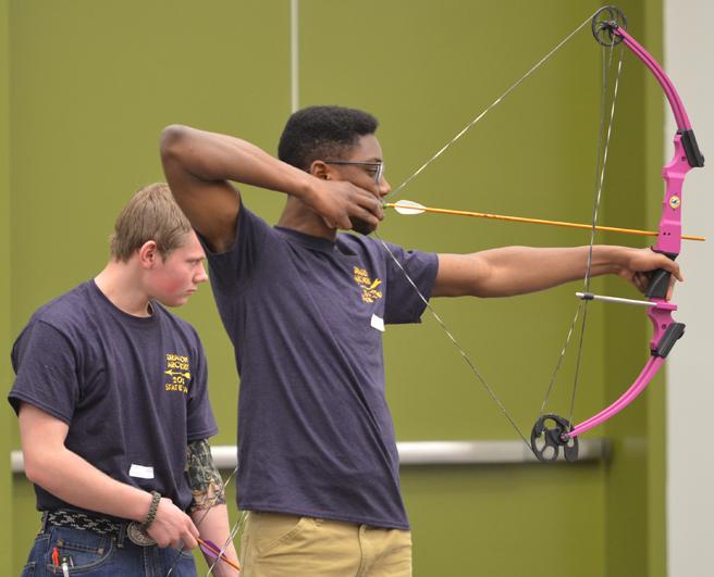 Senior+Andrew+Okumah+aims+towards+the+target+with+sophomore+Matt+Terrell+at+his+side.+Archery+attended+state+March+7+at+Hy-Vee+Hall+and+had+placed+6th+out+of+the+14+teams+who+attended+state.+