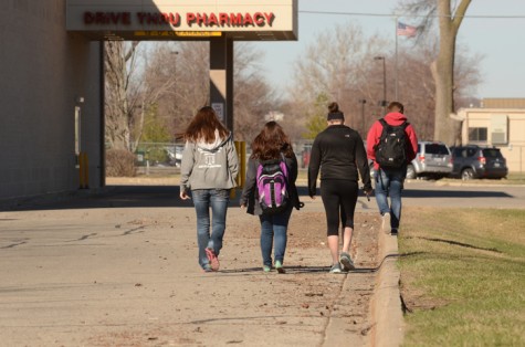 High school students who were parked at Walgreen's on the corner of 62nd Avenue and Merle Hay Road move their cars before they can be towed.