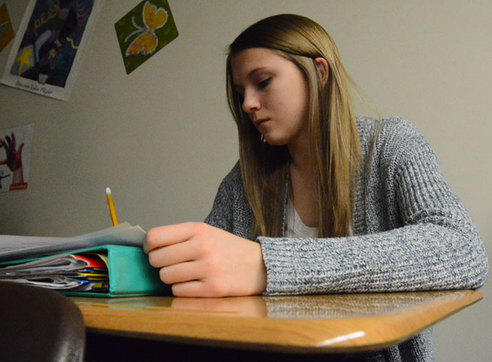 Sophomore Tallie Kerr works on an assignment in Integrated Language Arts (ILA) while watching a video about Nazi Germany in class. Kerr is a dedicated to her studies and is known by friends and family as being hard-working, funny and outgoing. 