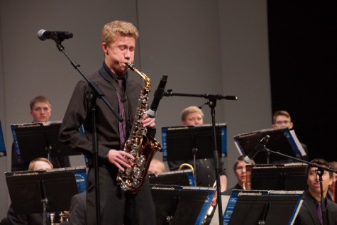 Sophomore Kyle Burgess plays his alto saxophone solo during the song