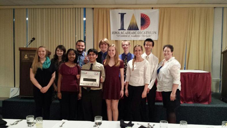 Academic Decathlon members pose for a photo holding their second place plaque from the state competition. Out of the eight team members, seven were all awarded medals and all team members placed within the top 13 in their divisions.