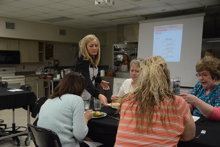 Senior Taylor Anthony serves staff members their lunches April 9. 