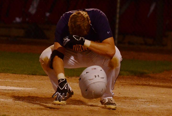 Graduated senior Clayton Holcomb drops his helmet and falls to the ground after striking out as the final batter for the Dragons ending the game. The varsity baseball team played against the East Scarlets July 22 for the Substate tournament final. 