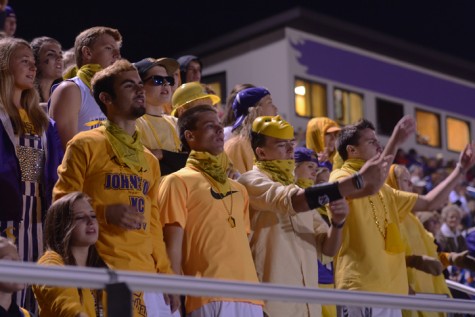 Seniors Sam Linder, Jake Page, and Joe Thatcher cheer while in the senior student section. During the varsity football against Waukee Sept. 18 the student section all wore gold to support.