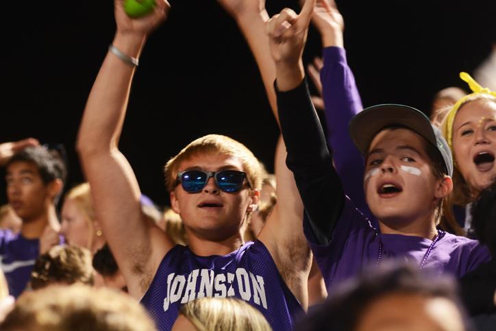 During half-time senior Cade Wagner raises his arms up in excitement with senior Hunter Rose at his side. The varsity football team played against the Urbandale Jayhawks Sept. 11 at home. 