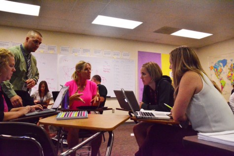 P.E. teacher Deb Nicholson talks to a small group of teachers about how they can better students' education as part of the TLC program. The meeting took place in Government teacher Tom Griffin's room Sept. 16.