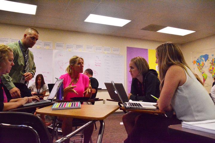 P.E. teacher Deb Nicholson talks to a small group of teachers about how they can better students' education as part of the TLC program. The meeting took place in Government teacher Tom Griffin's room Sept. 16. 