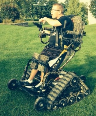 Graduated senior Mason Rumpf tests out his Action TrackChair. Rumpf plans to use the chair to help friends and neighbors with various types of yard work.