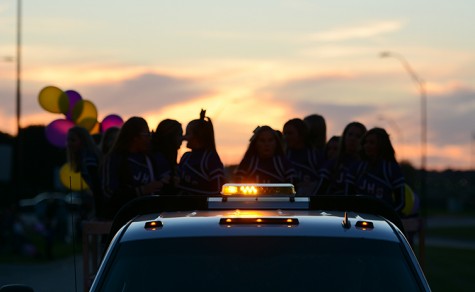 Community members march in homecoming parade