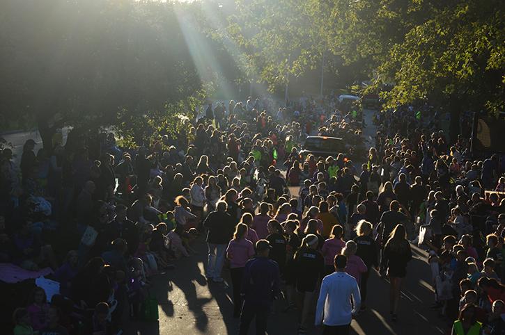 A sea of people crowd the streets to walk in the parade while families and fellow students sit on the side lines to catch goodies. The homecoming parade started across from Panera and ended at the high school Oct. 1 starting at 6 p.m.