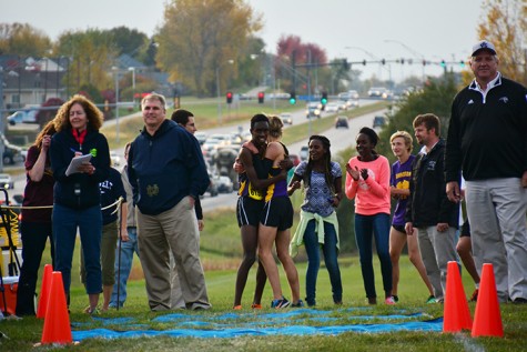 Senior Zach Smith and junior Patrick Bose hug after Bose finished first at conference with Smith in second. The boys team placed second in the meet Oct. 22 at the DMACC campus.