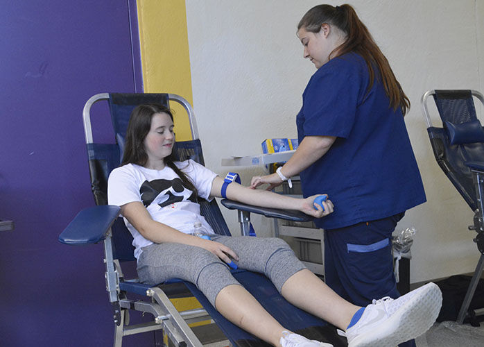 Junior Cassie Corell has her pulse checked before giving blood at the annual blood drive on Nov. 4. Over 100 students participated in annual fall blood drive. 