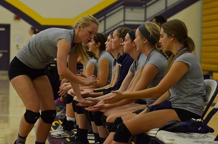 Senior Bailey Knopf runs down the line of those on the sideline giving them all high fives to celebrate after scoring a point. Girls varsity volleyball against the Roosevelt rough riders 3-0 Oct. 29 allowing them to proceed to the regional finals. 