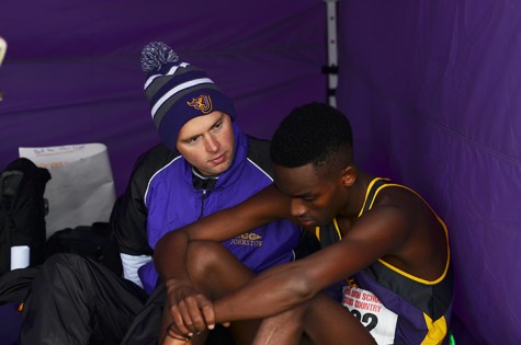 Coach Matt Jaschen sits down to talk with junior Patrick Bose after his race. Bose faced unfortunate circumstances during his race that altered his performance.