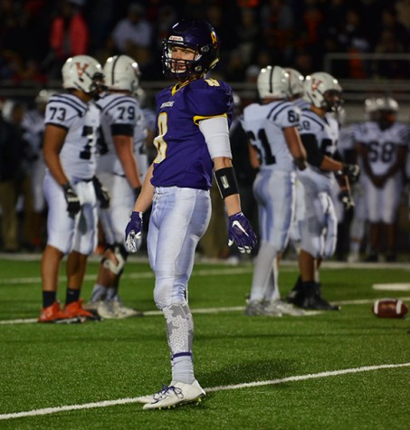 Senior Karl Rasmussen stands towards the sideline while looking out to the crowd. Rasmussen recently was awarded the Iowa Bankers Association student athlete award.