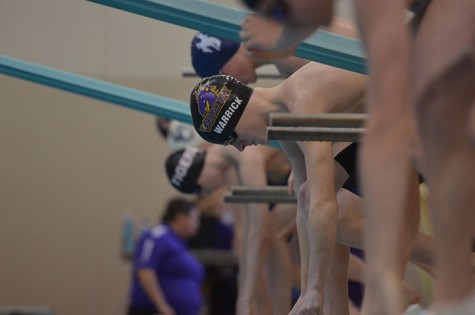 Positioning himself into his lane sophomore Ran Warrick gets ready for the 200 meter freestyle. Warrick placed in third with a final time of 1:57:17.