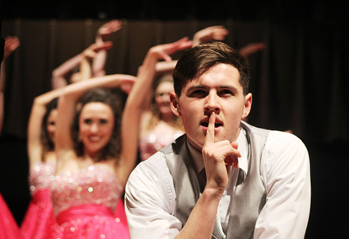 Finishing the song Little Secret,  junior Trent Wignall of Innovation, shushes the audience during the show choir student show held on Jan. 14. Innovation will compete again Saturday, Feb. 27 at Cedar Rapids Kennedys Raise the Roof invitational.