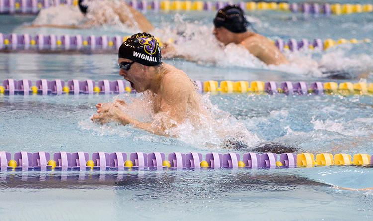 Junior Trent Wignall takes a breath during the 100 meter Breaststroke. The boys swim team placed second in the District swim meet Feb. 6. 