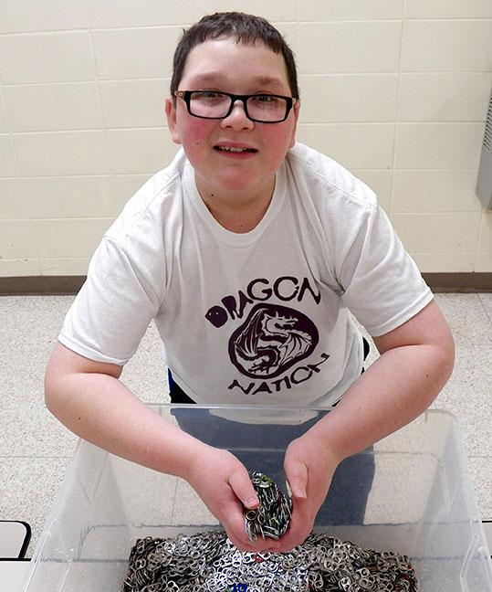 Sophomore Jack Marren holds pop tabs that will be donated to the Ronald McDonald House at the end of the year. Darren started collecting the pop tabs when he was in sixth  grade.