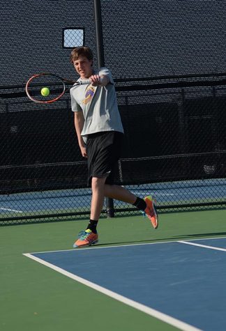 Sophomore Noah Hoppenjans strikes the ball during his doubles match April 26. Hoppenjans's double partner was senior Bernardo Duarte