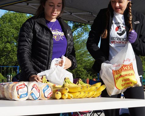 Prepping for potentially hungry participants juniors Sophie Catus and Madison Mehls set out bananas and other foods. Participants were free to pick up snacks and water bottles after completion of the race.