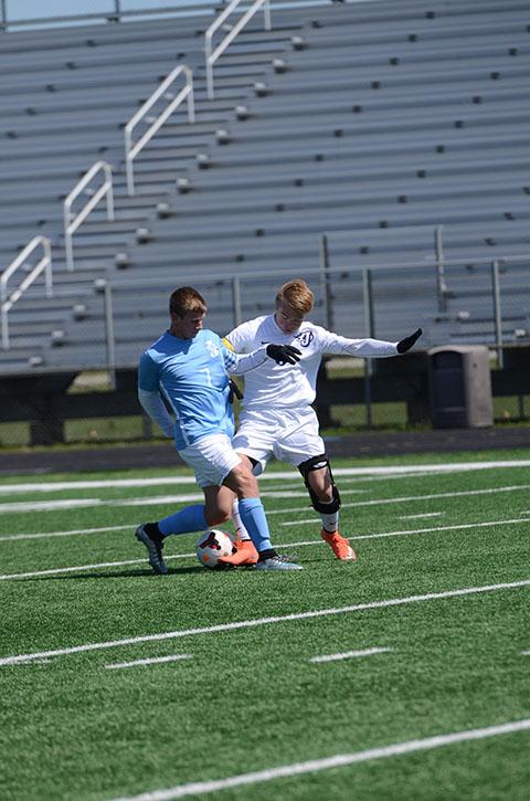 Senior Cade Wagner attempts to steal the ball from the opposing team. The varsity team finished 13-4, with the only losses coming to DSM Lincoln, Waukee, Urbandale, and WDM Valley.